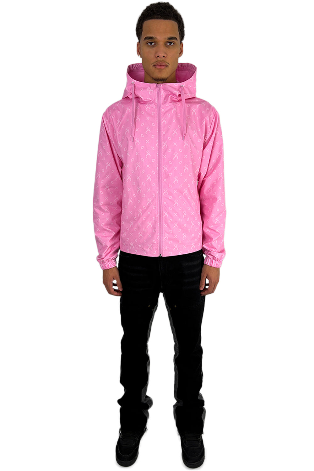 Model trägt eine rosa Miami Windbreaker Jacke mit durchgehendem Frontreißverschluss und Kapuze, die das charakteristische Sterlingz-Muster zeigt.
